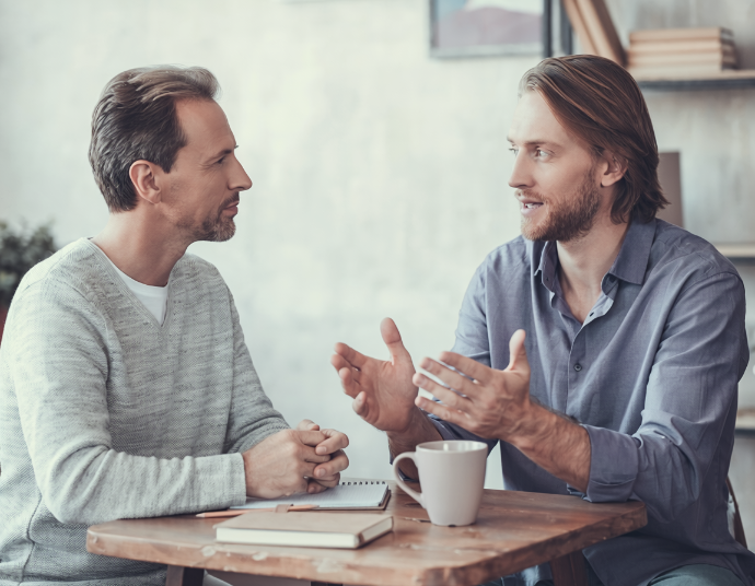 Two people in a focused conversation across a table