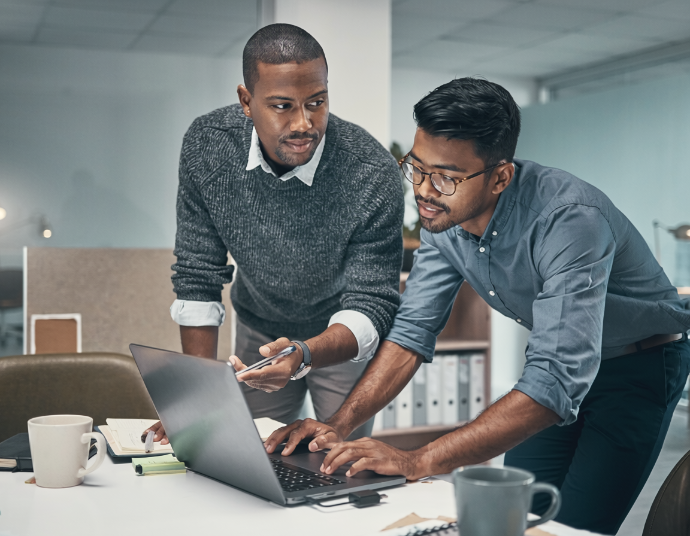 Small team working together around a laptop