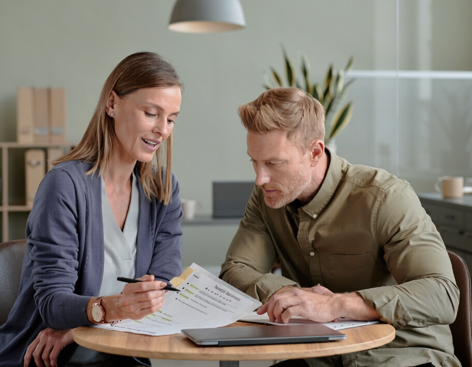 Two people reviewing a benefits document together