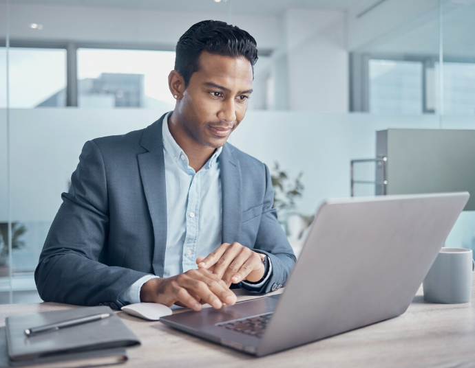 Professional reviewing a laptop in a modern office